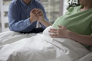 Pregnant Woman Holding Hands with her Husband